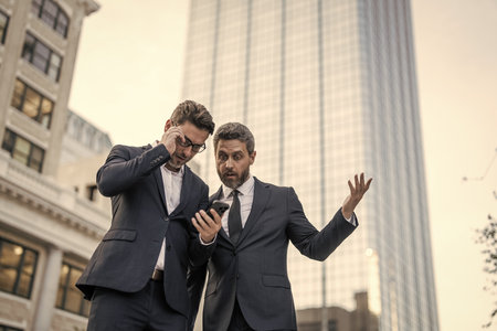Businessmen checking business chat. Business men freelancing outdoor. Business online. Men working...