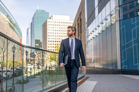 Business success of businessman. Businessman in suit. Top manager walking. Rich man in suit. Business success man outdoor. Businessman walk to business successful meeting in city. Financial districtの写真素材