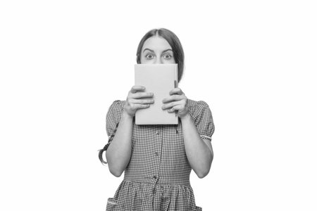 Teen girl study at school. Back to school. Reading education. Knowledge and education. Teen girl reading school book. Read a book. Student literature reader. Student isolated on whitの写真素材