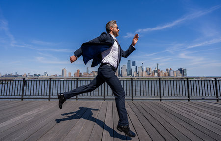 Businessman running to success. Business success. Successful businessman hurrying. Business man. Business success in big city. Next Stepsの写真素材