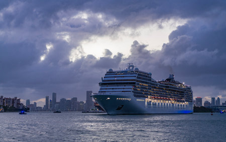 Ship departing port. Miami tour. Cruise ship voyage. Aerial cruise vacation in summertime. Cruise ship tour. Travel adventure. Aerial view luxury liner voyage. Massive ship on dramatic skyの写真素材
