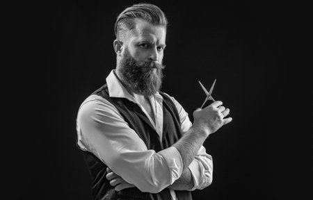 Barbershop hair master man hairdressing and barbering with scissors isolated on blackの写真素材