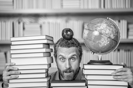 bookworm man in classroom. school teacher with book literature. education in school library. man...