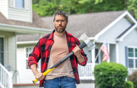 Lumberjack sweating hold heavy axe. Strong man work in neighborhood. Lumberjack men with axe....