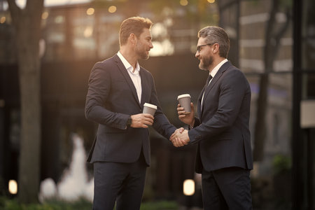 Business deal. Businessmen handshaking after contract deal. Successful agreement in business deal. Businessmen dealing outdoor. Partnership concept. Handshaking. Business partnershipの写真素材