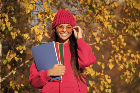 autumn nature in september. school girl study in autumn. education in modern school. autumn style of...