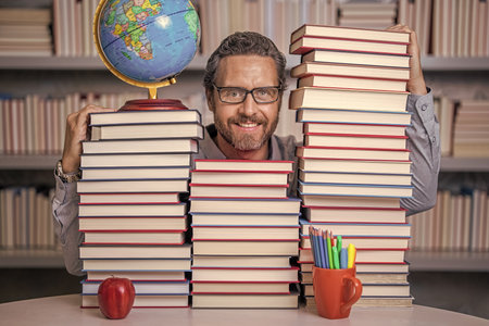 teachers and knowledge day. clever school teacher. bookworm man in classroom. school teacher with...