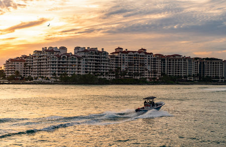 Vacation on summer. Fisher island building. Luxury motor boat yacht. Yacht go to marina. Boating and...