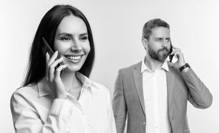 Phone call to colleague. Businesspeople talking on phone isolated on white. Businesspeople using phone for conversation. Business communication in office. Business negotiation call. Selective focusの写真素材