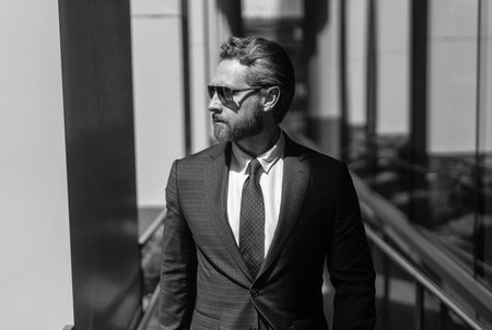 Portrait of handsome man CEO. Successful future vision. New opportunities. Businessman in office building. Successful business boss. Businessman suit. Business man in modern glass office. Working dayの写真素材