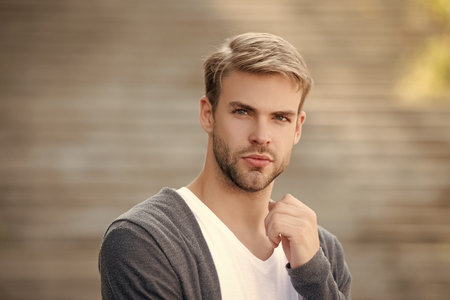 Man with trendy looking hair. Casual male style portrait. Millennial face portrait. Young millennial man outdoor. Stylish man portrait. Casual style of man. Guy has stylish hair. Modern men hairstyleの写真素材