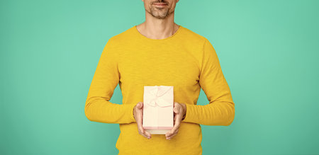 Mature man on February 14. Man give present gift box for Valentines day. Happy Valentines day. Mens...