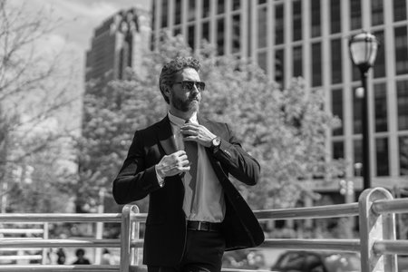 Businessman in suit. Man in suit go to office. Top manager. Confident boss in city. Business success. Businessman walk outdoor. Man on city street outdoor. Professional leader CEO. Core competencyの写真素材