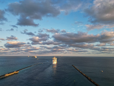 Aerial view of luxury liner voyage. Ship leaving Miami beach port. Miami tour. Cruise ship voyage. Aerial view of cruise in summer vacation. Cruise ship tour and travel at sea. Tour voyageの写真素材