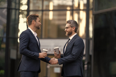 Businessmen handshaking after contract deal. Successful agreement in business deal. Businessmen dealing outdoor. Partnership concept. Handshaking. Business partnership. Business deal. Copy spaceの写真素材