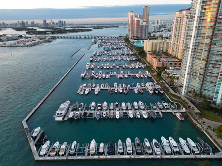 Yacht docked at Miami marina. Aerial view of coastline in Miami. Sailboat cruising along the Miamis shore. Miami skyline above harbor. Famous Miami Beach marine from above. Marina with yachts.の写真素材
