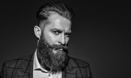 Businessman with beard. Brutal bearded man isolated on grey. Ambitious man in elegant suit menswear....