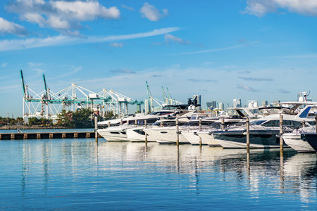 Yachting marina. Luxury yacht charter. Miami port marina. Luxury yachting in summer. Docked yacht in Miami beach. Marina luxury cityscape. Docked charter yacht. Motorboat docked in harborの写真素材
