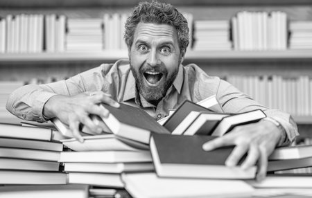 school professor reading books in library. teacher of literature school lesson. college teacher in classroom. school classroom full of books. school education for professor teacher or studentの写真素材
