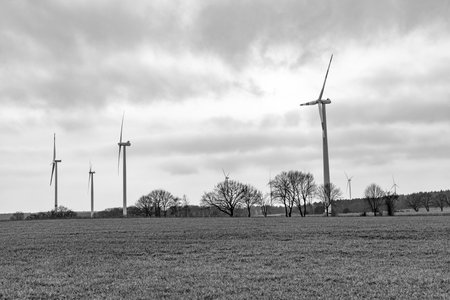 green energy concept. Wind mill for renewable electric energy production. Windmill tower in a rural...