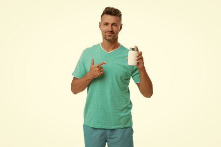 Man with pill or vitamin. Presenting energy remedy. Multivitamins and vitamin. Daily supplement....