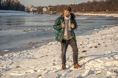man in winter jacket standing outdoors. stylish man in winter jacket outdoor. man in winter jacketの写真素材