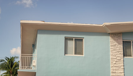 Modern apartment building facade. Apartment building with exterior detail. View of building facade. Residential building architecture. Architectural exterior. House exterior fragment. House for rentの写真素材