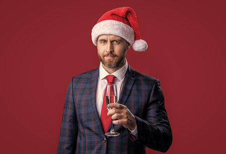 celebrating christmas. businessman celebrating christmas isolated on red. christmas businessmanの写真素材