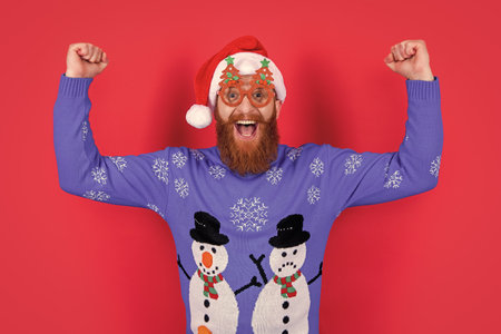 new year party fun. glad man in party glasses have fun at new year. santa man have fun at new yearの写真素材