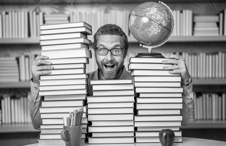 bookworm man in classroom. school teacher with book literature. education in school library. man bookworm getting knowledge. teachers and knowledge day. clever school teacher. Thinking like a geniusの写真素材