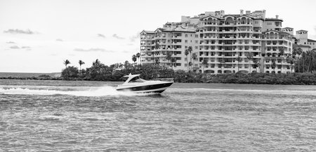 Miami Fisher island and luxury yacht. Miami beach, Florida. Landscape of luxury Fisher island building with yacht boat. Summer in Miami. Luxury traveling on boat. Fisher island with yacht boatの写真素材