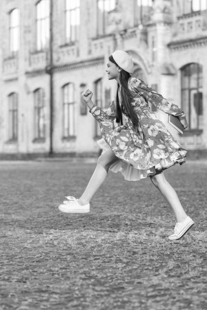 School education. Students life. Teen girl jump back to school. Knowledge day. Education in school. Girl student jump outdoor. September 1. Time to study. Knowledge and education. Stylish and happyの写真素材