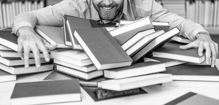 school teacher in library. book lover man gets educated. knowledge day. teacher get knowledge from books. man teacher at the bookstore. college tutor reading books. back to school. choose your bookの写真素材