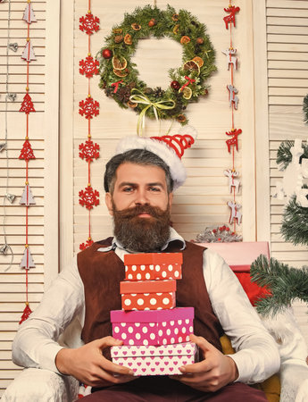 Present form Christmas tree. Christmas celebration. New Year holiday. Happy bearded man hold gift or present box. Happy New Year. Christmas shopping sale. Xmas present. Santa Clausの写真素材