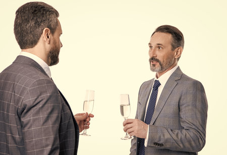 partnership and business success. businessmen isolated on white. successful business partnership. two successful businessmen partner celebrating business success with champagne. cheeringの写真素材