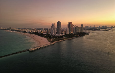 Night city aerial view. Luxury skyscraper in Miami, Florida. City skyline in evening sunset. Aerial cityscape. Miami South beach at night. Aerial skyscraper cityscape at night. Sunset at sea cityの写真素材