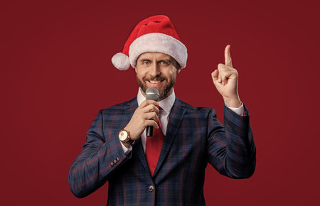 merry xmas. inspired with idea businessman presenter at xmas isolated on red. xmas businessmanの写真素材