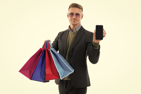 Man buy shopping bag isolated on white. Man with shopper bag. Purchasing present online. Buy and pay online. Man pay online in internet shop. Big discount and shopping sale. Cyber Mondayの写真素材