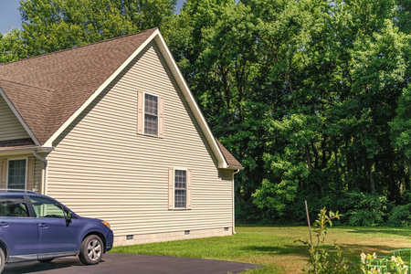 Private residential architecture with car. Suburban house architecture. Cozy suburban house. Architecture concept. Home in suburb. Residential house. Private driveway. Suburban home in neighborhoodの写真素材