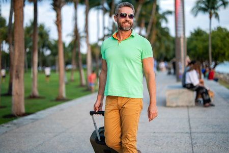 Summer tour. Traveler enjoy summer trip. Hispanic tourist traveler walk on street. Tourist with...