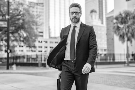 Businessman walk in the city. Business man crossing the street. Walk of business man. Businessman in New York. Business success. Businessman in suit walk outdoor. Walk to American successの写真素材