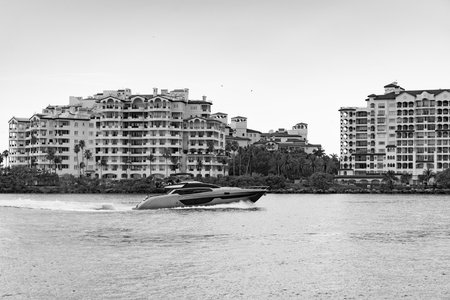 Fisher island with yacht boat. Miami Fisher island and luxury yacht. Miami beach, Florida. Landscape of luxury Fisher island building with yacht boat. Summer in Miami. Luxury travel on boatの写真素材