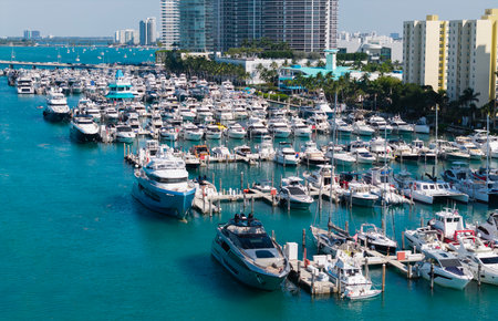Aerial view of luxury yachts in Miami marina. Scenic panorama of boats and skyscrapers in Miami marina. Cruise yacht sailing along the Miami coastline. Miami Beach harbor. Sailboats and yachts at pier.の写真素材