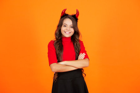 Girl devil ready for Halloween party isolated orange. Trick or treat. All Hallows party celebration....