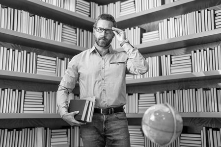 school geographer with globe in classroom. Man on lesson in class. Exploring the world. man tutor at school exam. tutor with book at lesson. teaching school subject. Teacher in school classroomの写真素材