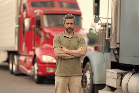 Truck driver. Trucking owner. Professional occupation. Hispanic confident man in front of truck....