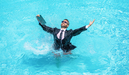 Happy businessman on summer vacation. Freelancer has remote work online. Businessman in suit with...