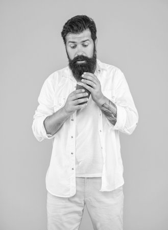 shocked man has coffee break in studio.の写真素材