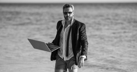 Summer business. Businessman relaxing at beach. Remote working. businessman relax at beach....