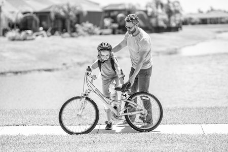 dad and daughter duo pedaling through picturesque landscape. supportive dad guiding his daughter...